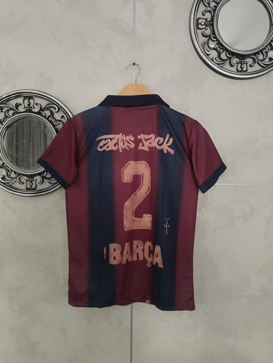 Maroon and navy sports jersey with number 2 and 'Barça' text on a hanger against a tiled wall.