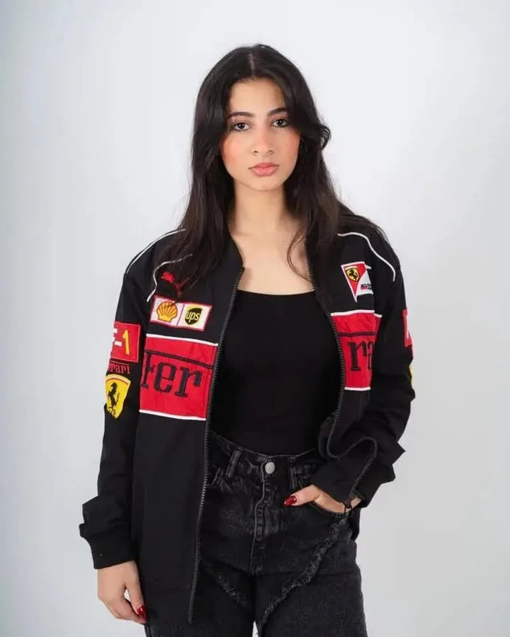 Woman wearing a black jacket with red and white patches on a white background