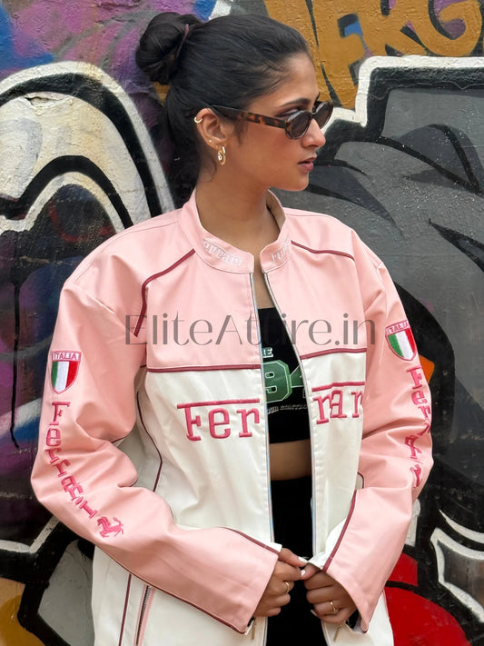 Person wearing a pink and white jacket with branding in front of a graffiti wall.