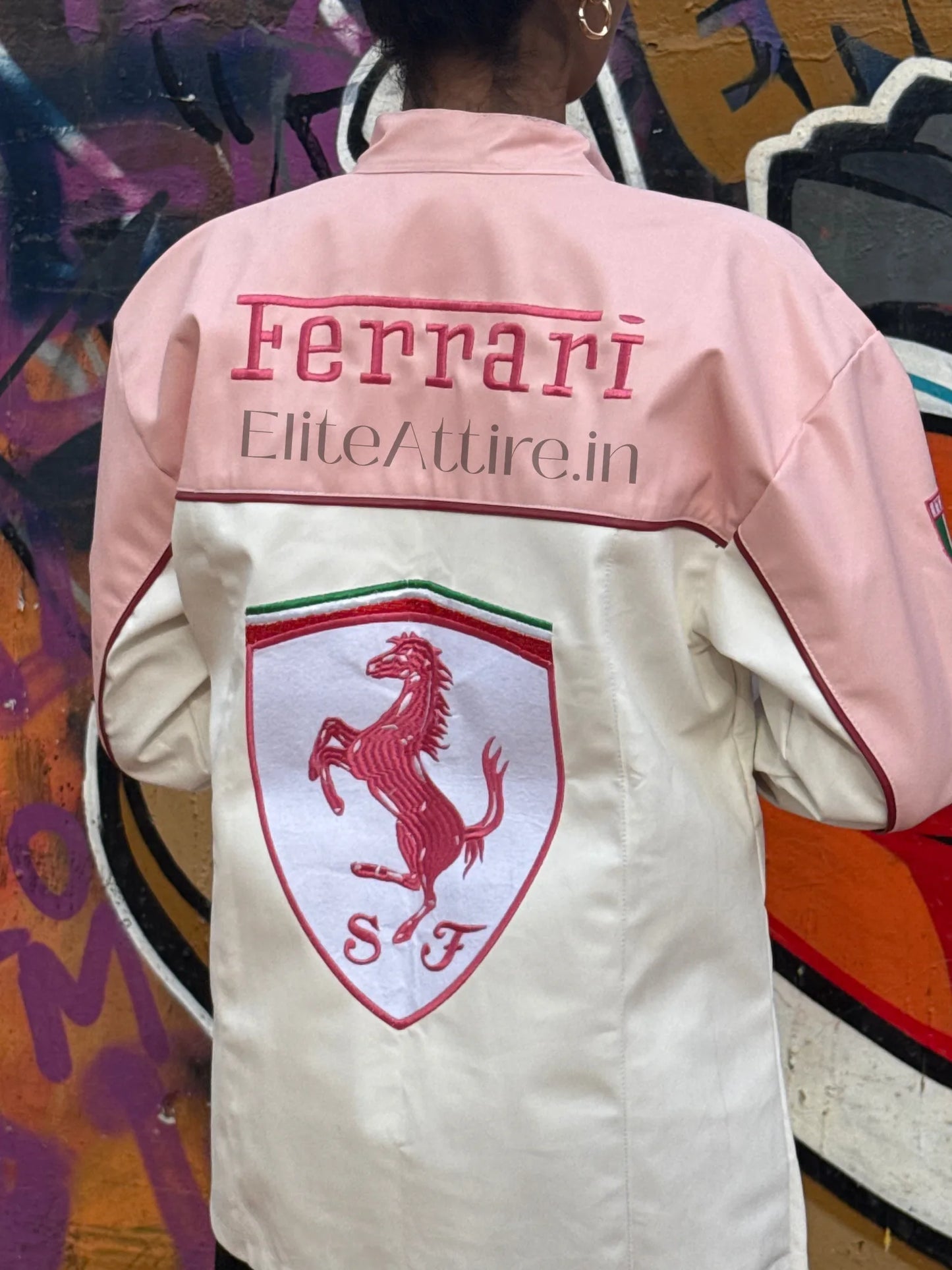 Pink and white jacket with Ferrari logo and branding on a colorful background