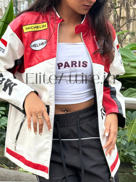 Person wearing a red, white, and black jacket with visible branding, standing outdoors.