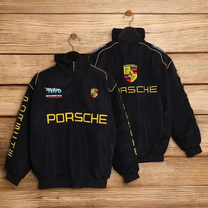 Two black Porsche jackets with logos on a wooden background