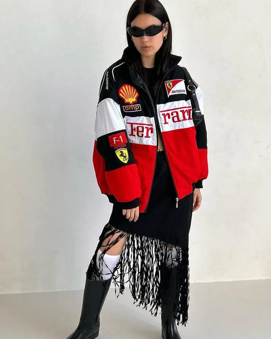 Person wearing a colorful jacket with various logos on a plain background