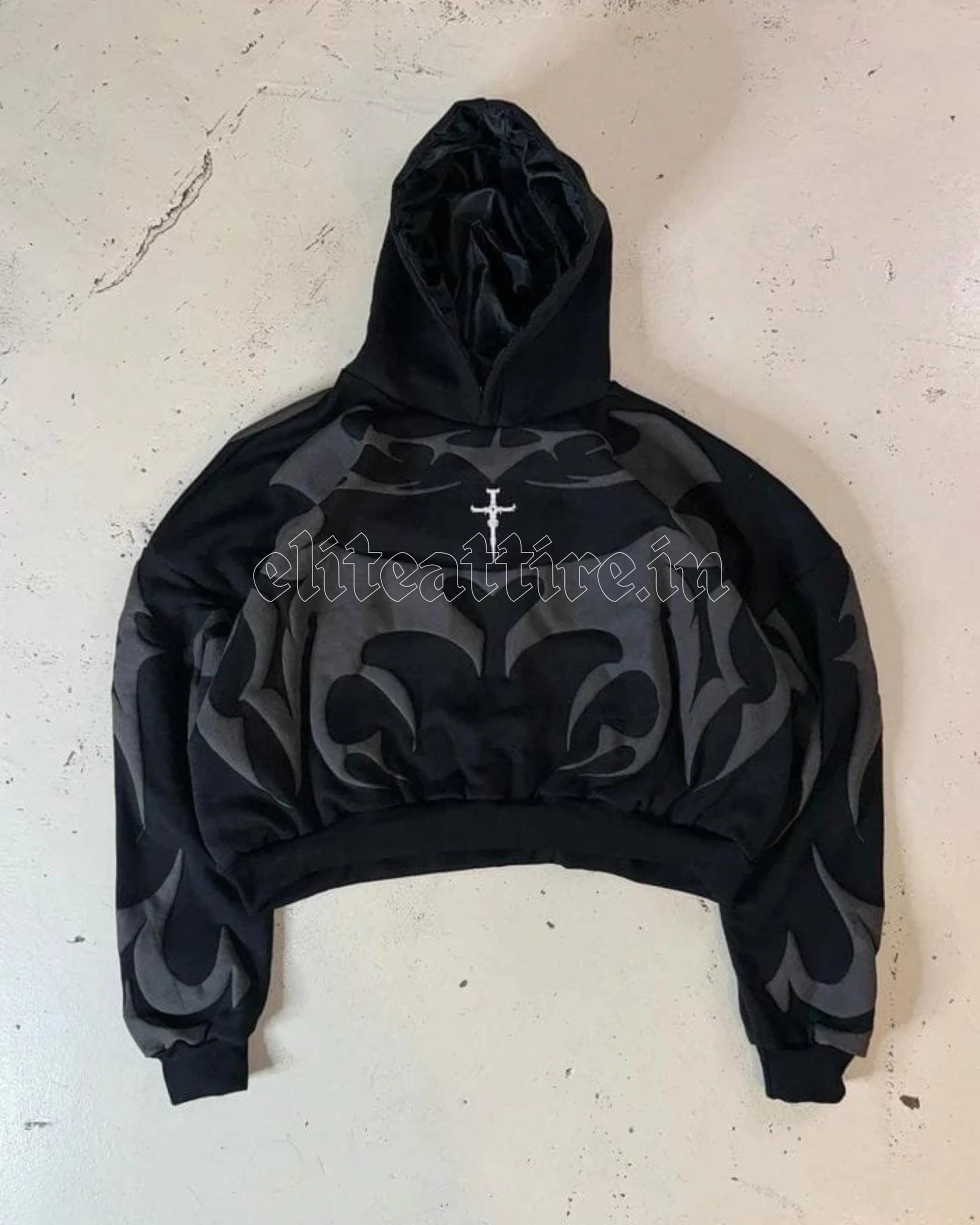Black hoodie with gray pattern and cross design on a light gray background