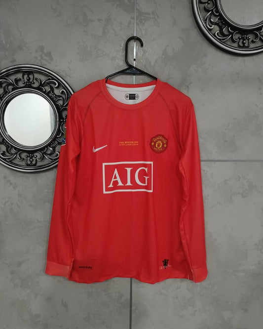 Red sports jersey with visible branding on a gray wall.