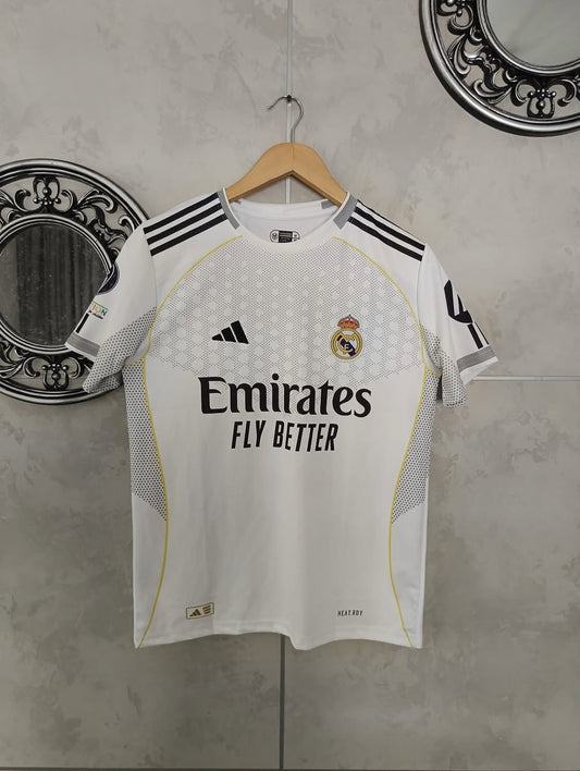 White sports jersey with black stripes and branding on a hanger against a gray wall.