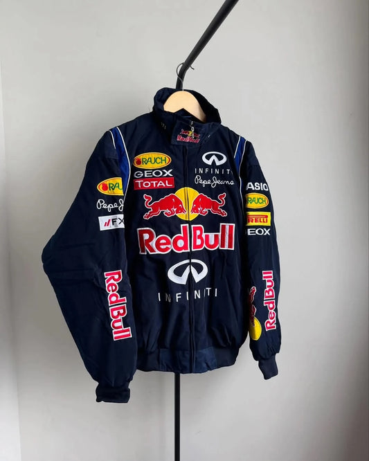 Navy blue jacket with Red Bull and Infiniti logos on a hanger against a gray background
