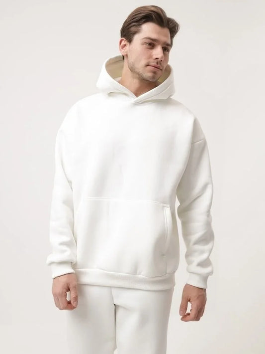 Man wearing a white hoodie on a plain background